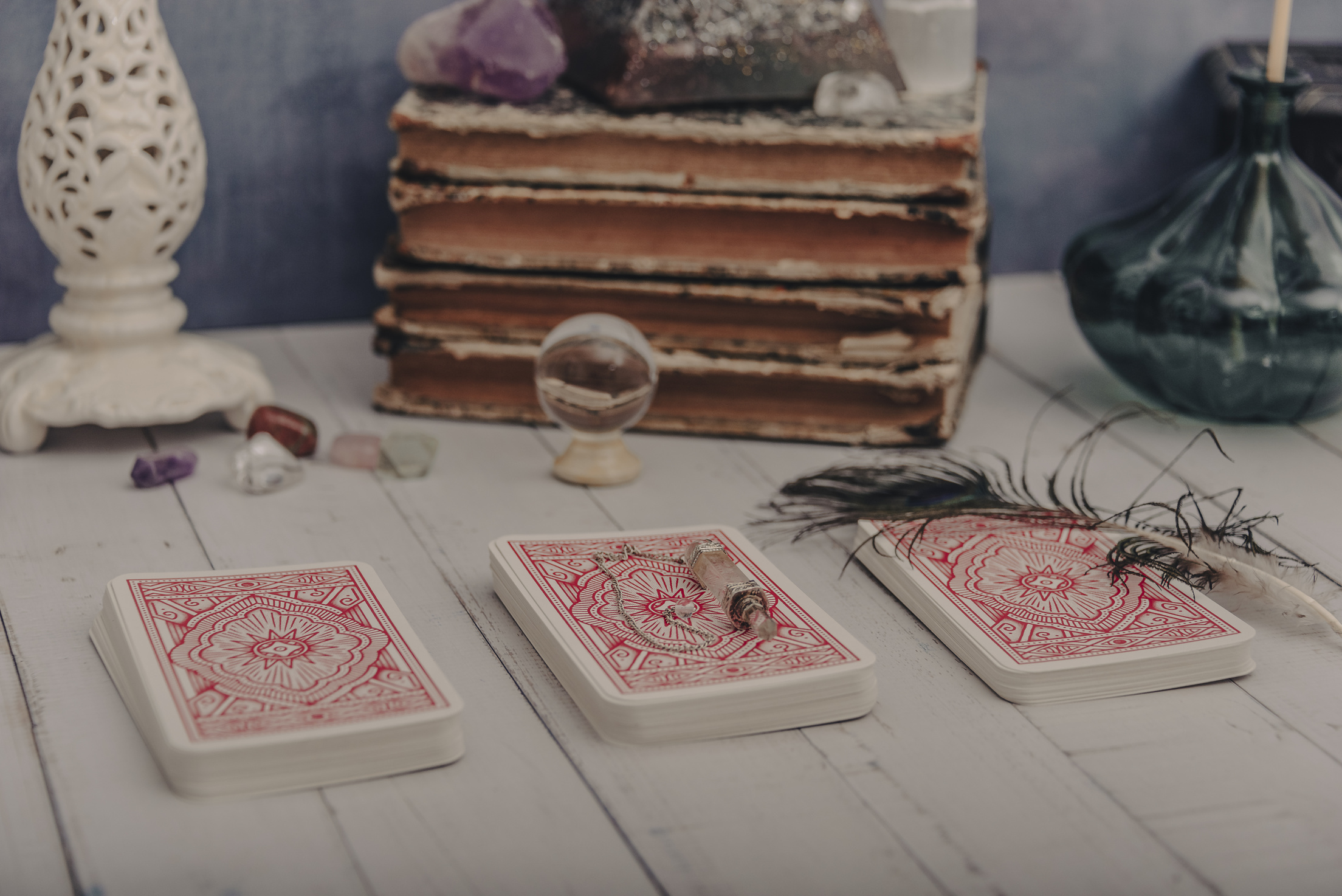 Fortune Telling a Deck of Tarot Cards with Other Fortune Telling Items Blue Pastel Background.